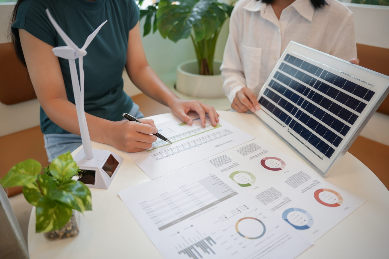 Solar panels green energy Business people working in green eco friendly office business meeting creative ideas for business eco friendly professional teaching corporate people sustainable electricity.